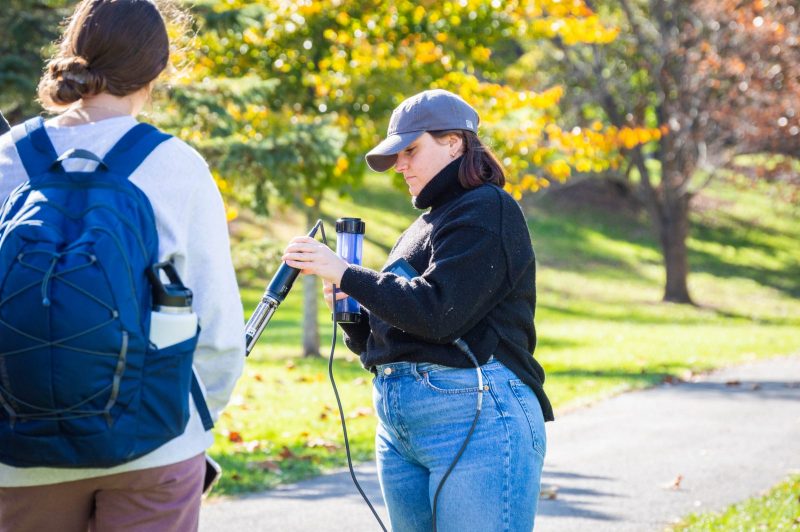 student showing testing equipment to other students