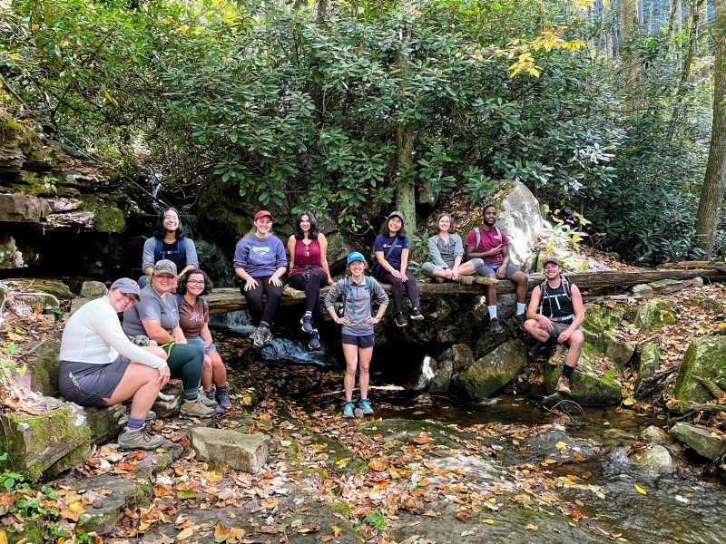 students stand in a creek