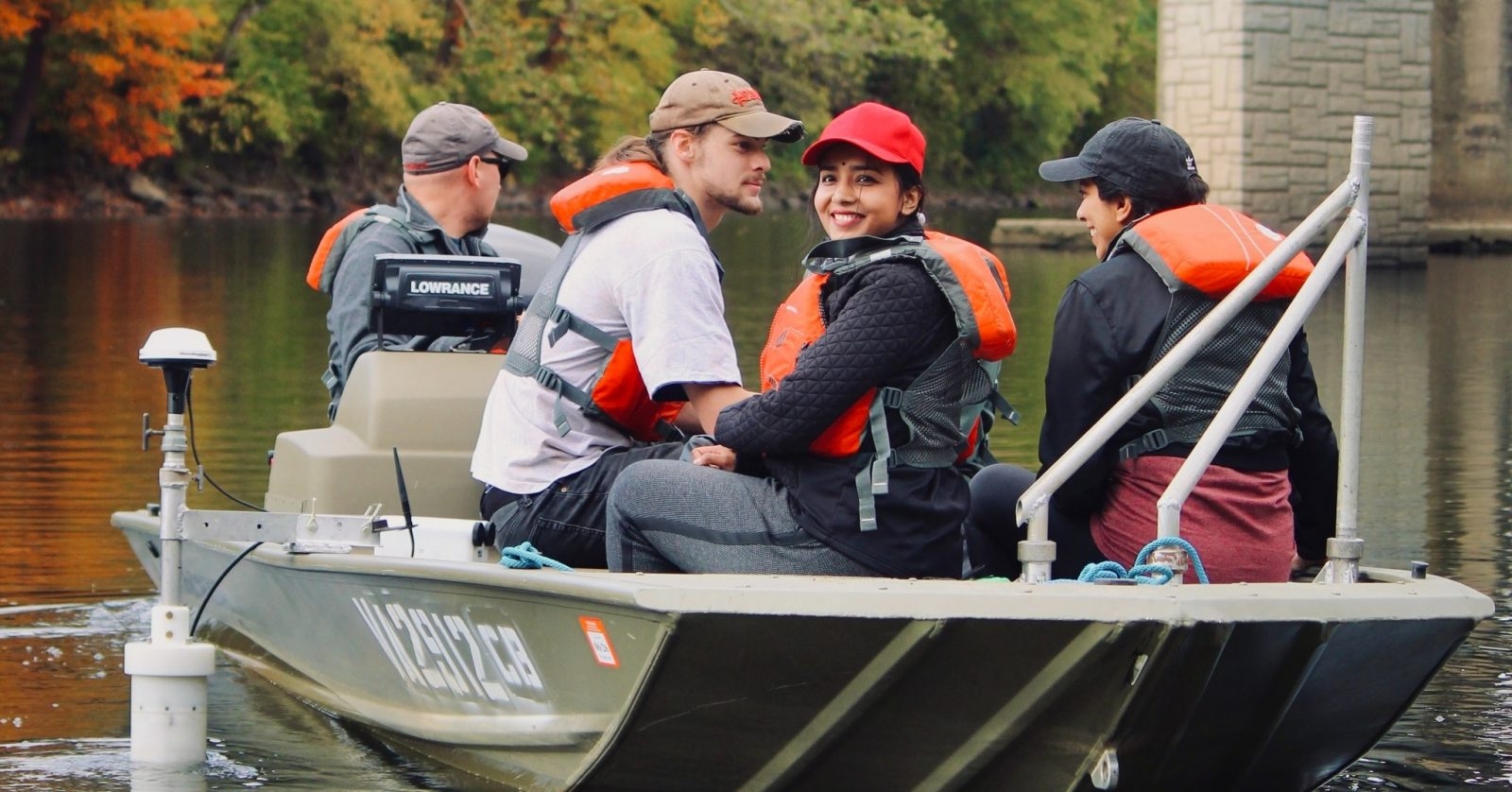 students and faculty on a boat 