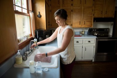 woman filling water container 